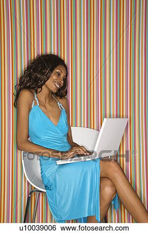 Young adult African American female face sitting with laptop. View Large Photo Image Stock Photograph - Young adult African American female face sitting with laptop.. Fotosearch
