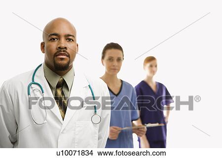Stock Photo - Portrait of African-American man and Caucasian women medical healthcare workers in uniforms standing against white background.. Fotosearch - Search Stock Images, Mural Photographs, Pictures, and Clipart Photos