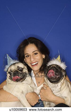Caucasian prime adult female holding two Pug dogs. View Large Photo Image Stock Image - Caucasian prime adult female holding two Pug dogs.. Fotosearch
