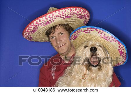 Fluffy brown dog and Caucasian male young adult wearing Mexican sombreros. View Large Photo Image Stock Photograph - Fluffy brown dog and Caucasian male young adult wearing Mexican sombreros.. Fotosearch