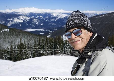 Caucasian senior man skier in goggles posing on mountain. View Large Photo Image Stock Photo - Caucasian senior man skier in goggles posing on mountain.. Fotosearch