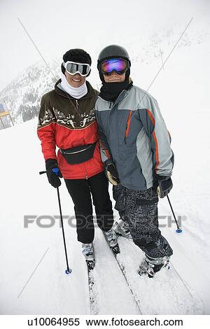 Stock Photography - Middle-aged mother with teenage son on snowy ski slopes.. Fotosearch