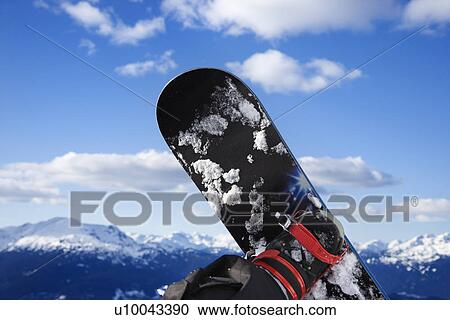 Stock Image - Snowboard and mountain.. Fotosearch