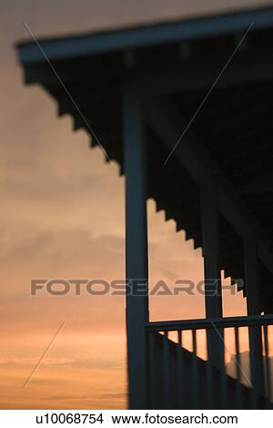 Beachfront porch silhouetted at sunset View Large Photo Image Picture - Beachfront porch silhouetted at sunset. Fotosearch