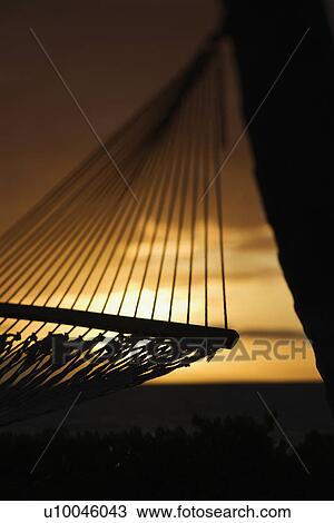 Close-up of hammock silhouette against ocean sunset in Maui, Hawaii, USA. View Large Photo Image Stock Image - Close-up of hammock silhouette against ocean sunset in Maui, Hawaii, USA.. Fotosearch
