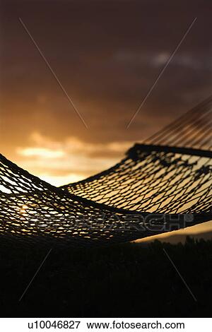 Close-up of hammock silhouette against ocean sunset in Maui, Hawaii, USA. View Large Photo Image Stock Photo - Close-up of hammock silhouette against ocean sunset in Maui, Hawaii, USA.. Fotosearch