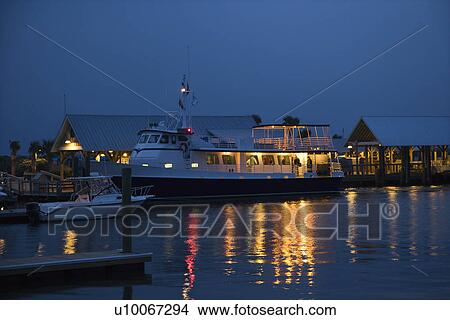 Cruise boat docked at night on Bald Head Island, North Carolina. View Large Photo Image Picture - Cruise boat docked at night on Bald Head Island, North Carolina.. Fotosearch