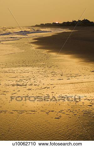 Stock Image - Golden beach at sunset.. Fotosearch
