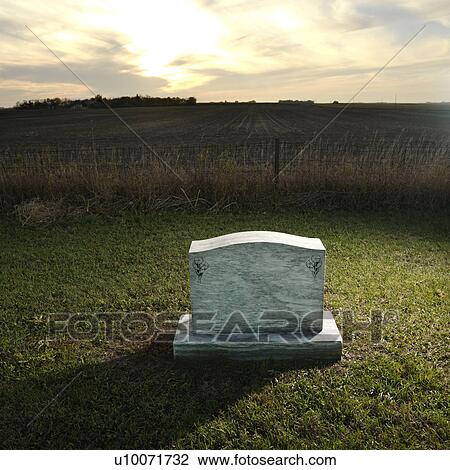 Headstone marking grave in rural countryside at sunset.  View Large Photo Image Stock Image - Headstone marking grave in rural countryside at sunset. . Fotosearch