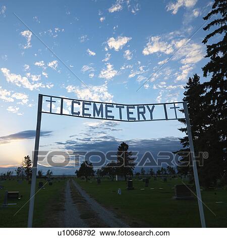 Stock Image - Sign over entrance to cemetary at dusk in rural South Dakota.. Fotosearch