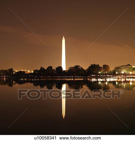 Stock Image - Washington Monument reflected in water at night in Washington, D. C., USA.. Fotosearch