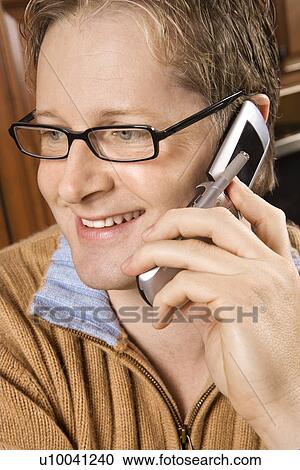 Caucasian man smiling and talking on cellphone. View Large Photo Image Stock Image - Caucasian man smiling and talking on cellphone.. Fotosearch