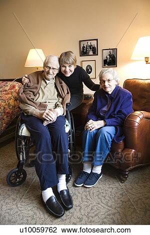 Caucasian middle-aged daughter with elderly parents in retirement community center. View Large Photo Image Stock Image - Caucasian middle-aged daughter with elderly parents in retirement community center.. Fotosearch