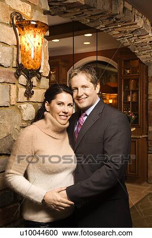 Caucasian woman and Caucasian man with arms around each other looking at viewer and smiling. View Large Photo Image Stock Image - Caucasian woman and Caucasian man with arms around each other looking at viewer and smiling.. Fotosearch