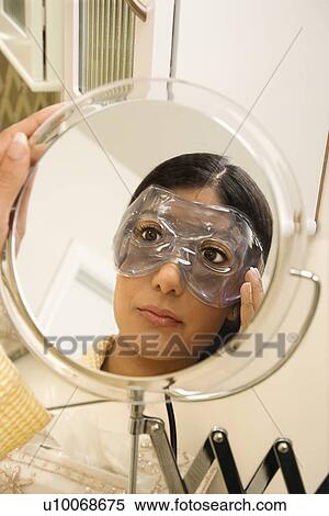 Close up mirror reflection of Asian/Indian young woman wearing eye mask. View Large Photo Image Stock Photography - Close up mirror reflection of Asian/Indian young woman wearing eye mask.. Fotosearch