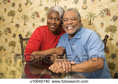 Portrait of mature African American couple embracing and smiling at viewer. View Large Photo Image Stock Image - Portrait of mature African American couple embracing and smiling at viewer.. Fotosearch