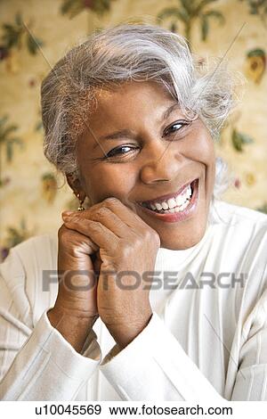 Portrait of mature African American woman smiling at the viewer. View Large Photo Image Stock Photo - Portrait of mature African American woman smiling at the viewer.. Fotosearch