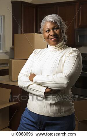 Portrait of middle-aged African-American female in kitchen with moving boxes. View Large Photo Image Stock Photography - Portrait of middle-aged African-American female in kitchen with moving boxes.. Fotosearch