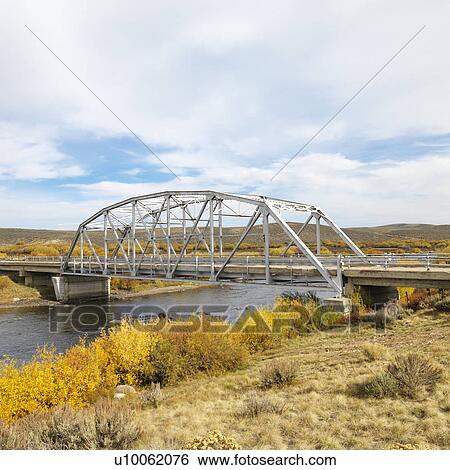 Bridge over stream in Wyoming. View Large Photo Image Stock Photograph - Bridge over stream in Wyoming.. Fotosearch