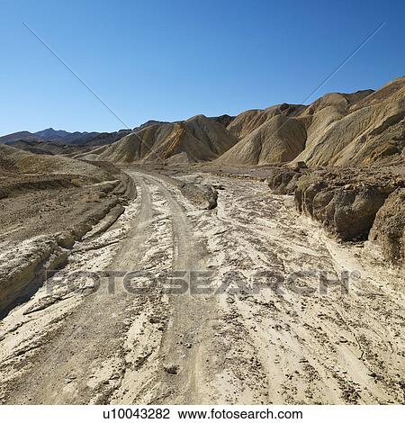 Dirt road through Death Valley National Park. View Large Photo Image Stock Image - Dirt road through Death Valley National Park.. Fotosearch
