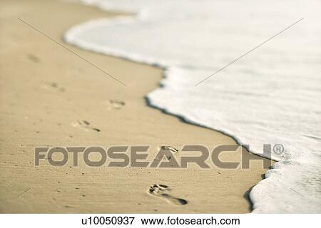 Scenic sandy coastline with footprints and waves. View Large Photo Image Stock Photo - Scenic sandy coastline with footprints and waves.. Fotosearch