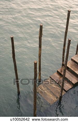 Stock Image - Steps leading from canal in Venice, Italy.. Fotosearch