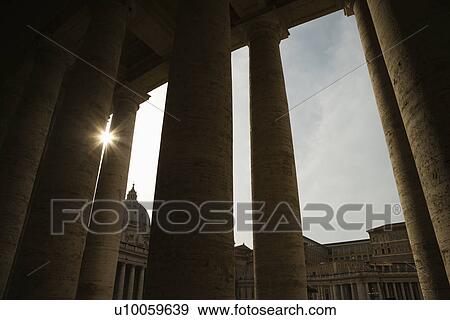 Sun peeking through doric columns in Saint Peter's Square in Vatican City, Italy. View Large Photo Image Stock Photo - Sun peeking through doric columns in Saint Peter's Square in Vatican City, Italy.. Fotosearch