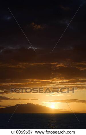 Stock Photo - Sunset over Pacific Ocean and Kihea island in Maui, Hawaii, USA.. Fotosearch