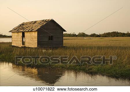 Worn out building in marsh on Bald Head Island, North Carolina. View Large Photo Image Stock Image - Worn out building in marsh on Bald Head Island, North Carolina.. Fotosearch