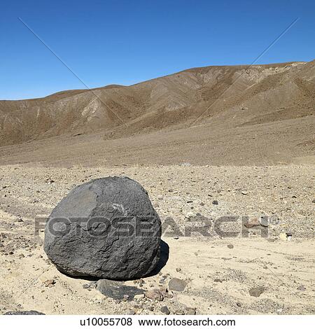 Boulder in barren landscape in Death Valley National Park. View Large Photo Image Stock Photo - Boulder in barren landscape in Death Valley National Park.. Fotosearch