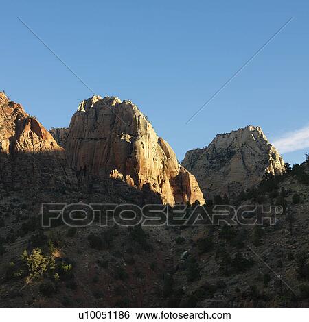 Rocky cliffs and rock formations in desert of Zion National Park, Utah. View Large Photo Image Stock Photograph - Rocky cliffs and rock formations in desert of Zion National Park, Utah.. Fotosearch