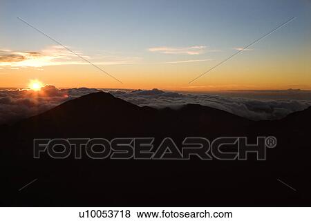Stock Photo - Shot of sunrise in Haleakala National Park in Maui, Hawaii.. Fotosearch