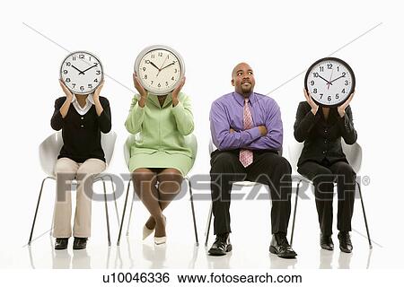 Businesswomen sitting holding clocks over faces while African-American businessman looks on. View Large Photo Image Stock Photograph - Businesswomen sitting holding clocks over faces while African-American businessman looks on.. Fotosearch
