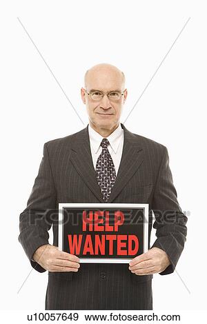 Stock Photo - Caucasian middle-aged businessman holding help wanted sign.. Fotosearch