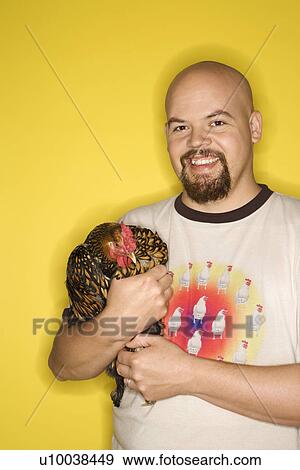 Caucasian mid-adult man holding Golden Laced Wyandotte chicken. View Large Photo Image Stock Photo - Caucasian mid-adult man holding Golden Laced Wyandotte chicken.. Fotosearch