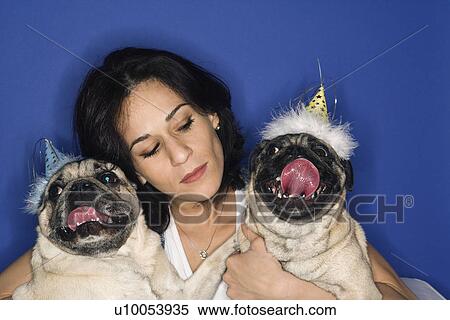 Caucasian prime adult female holding two Pug dogs. View Large Photo Image Stock Photography - Caucasian prime adult female holding two Pug dogs.. Fotosearch
