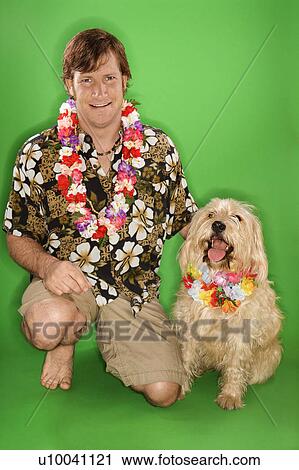 Caucasian young adult male kneeling with fluffy dog wearing leis. View Large Photo Image Stock Image - Caucasian young adult male kneeling with fluffy dog wearing leis.. Fotosearch