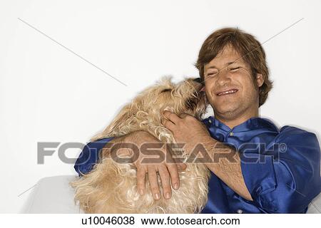 Male Caucasian young adult with fluffy brown dog. View Large Photo Image Stock Photo - Male Caucasian young adult with fluffy brown dog.. Fotosearch