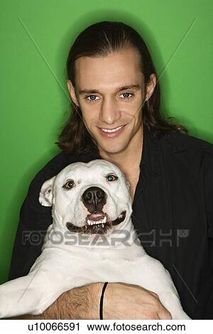 Caucasian mid-adult man holding white Pit Bull on lap. View Large Photo Image Stock Image - Caucasian mid-adult man holding white Pit Bull on lap.. Fotosearch