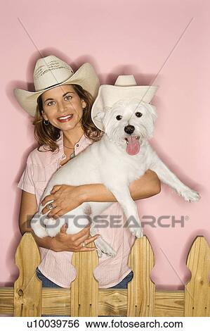 Stock Photograph - Caucasian prime adult female and white terrier dog wearing cowboy hats.. Fotosearch