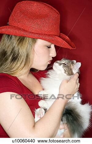 Young Caucasian female adult holding and kissing cat. View Large Photo Image Stock Image - Young Caucasian female adult holding and kissing cat.. Fotosearch