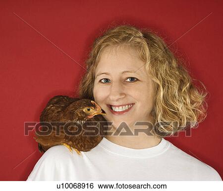 Caucasian mid-adult woman with chicken on shoulder. View Large Photo Image Stock Photograph - Caucasian mid-adult woman with chicken on shoulder.. Fotosearch