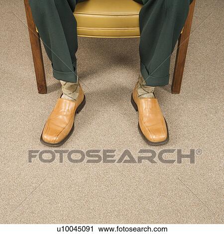 Close up of man sitting in chair wearing retro pants and shoes. View Large Photo Image Stock Image - Close up of man sitting in chair wearing retro pants and shoes.. Fotosearch