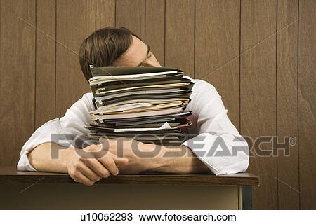 Mid-adult Caucasian male resting head on stack of paperwork. View Large Photo Image Stock Image - Mid-adult Caucasian male resting head on stack of paperwork.. Fotosearch