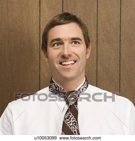 Stock Photo - Mid-adult smiling Caucasian male with necktie.. Fotosearch