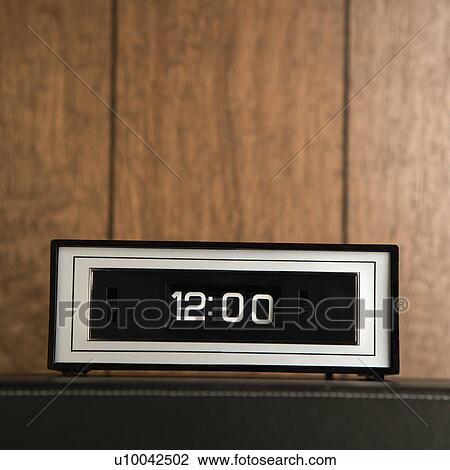 Retro clock set for 12: 00 against wood paneling. View Large Photo Image Stock Image - Retro clock set for 12: 00 against wood paneling.. Fotosearch