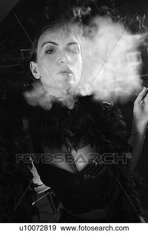 Stock Photo - Caucasian prime adult female smoking looking at viewer.. Fotosearch