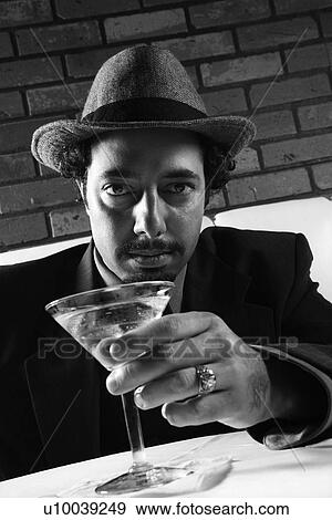 Caucasian prime adult male in retro suit sitting at table with martini looking at viewer. View Large Photo Image Stock Photo - Caucasian prime adult male in retro suit sitting at table with martini looking at viewer.. Fotosearch