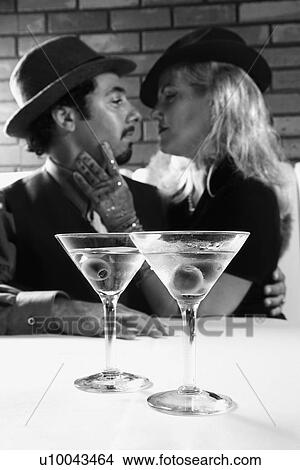 Picture - Caucasian prime adult retro male and female looking into eachother's eyes.. Fotosearch