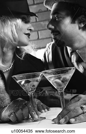 Stock Photography - Caucasian prime adult retro male and female looking into eachother's eyes.. Fotosearch